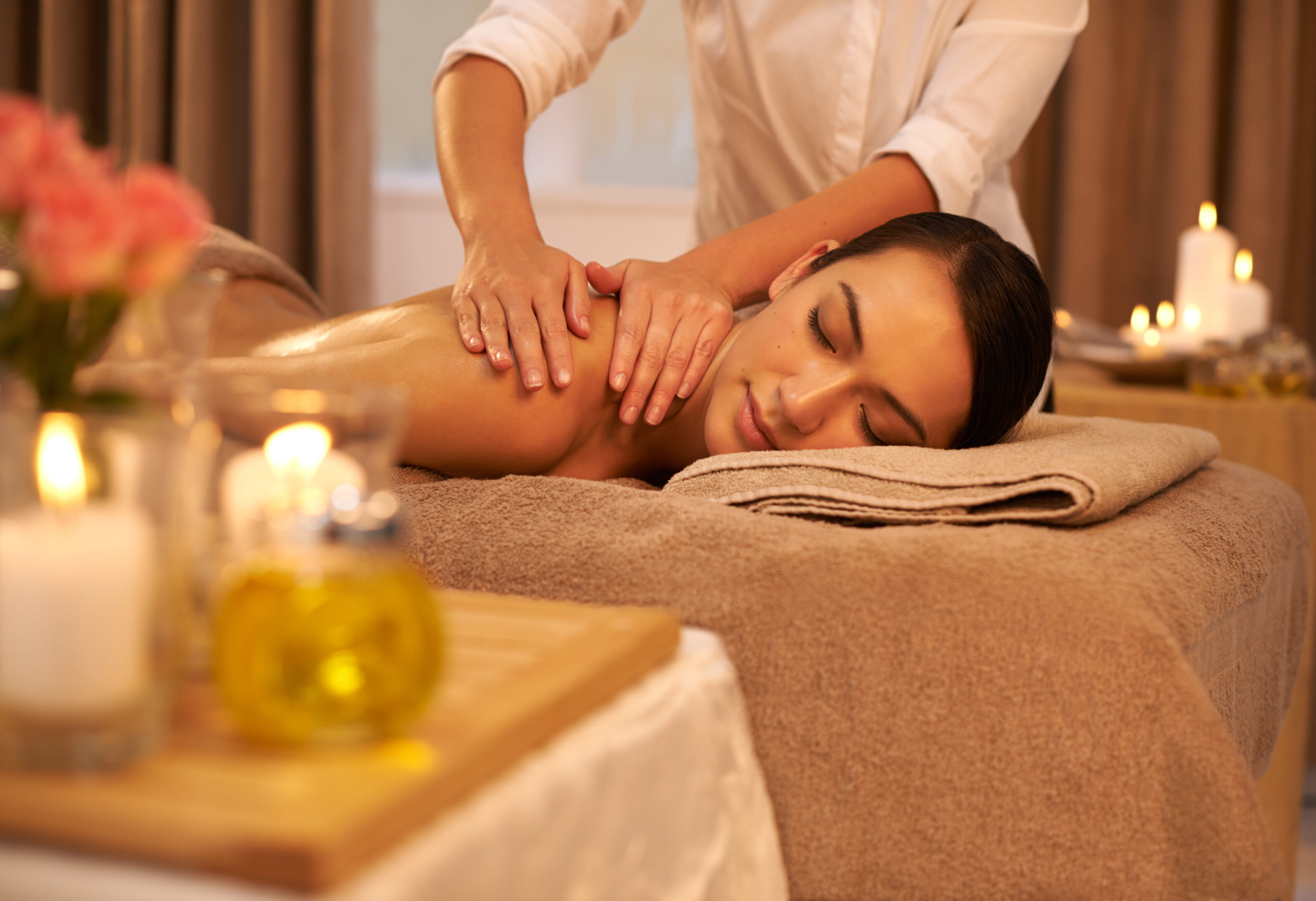 A woman enjoying a relaxing shoulder massage in a cozy spa setting.