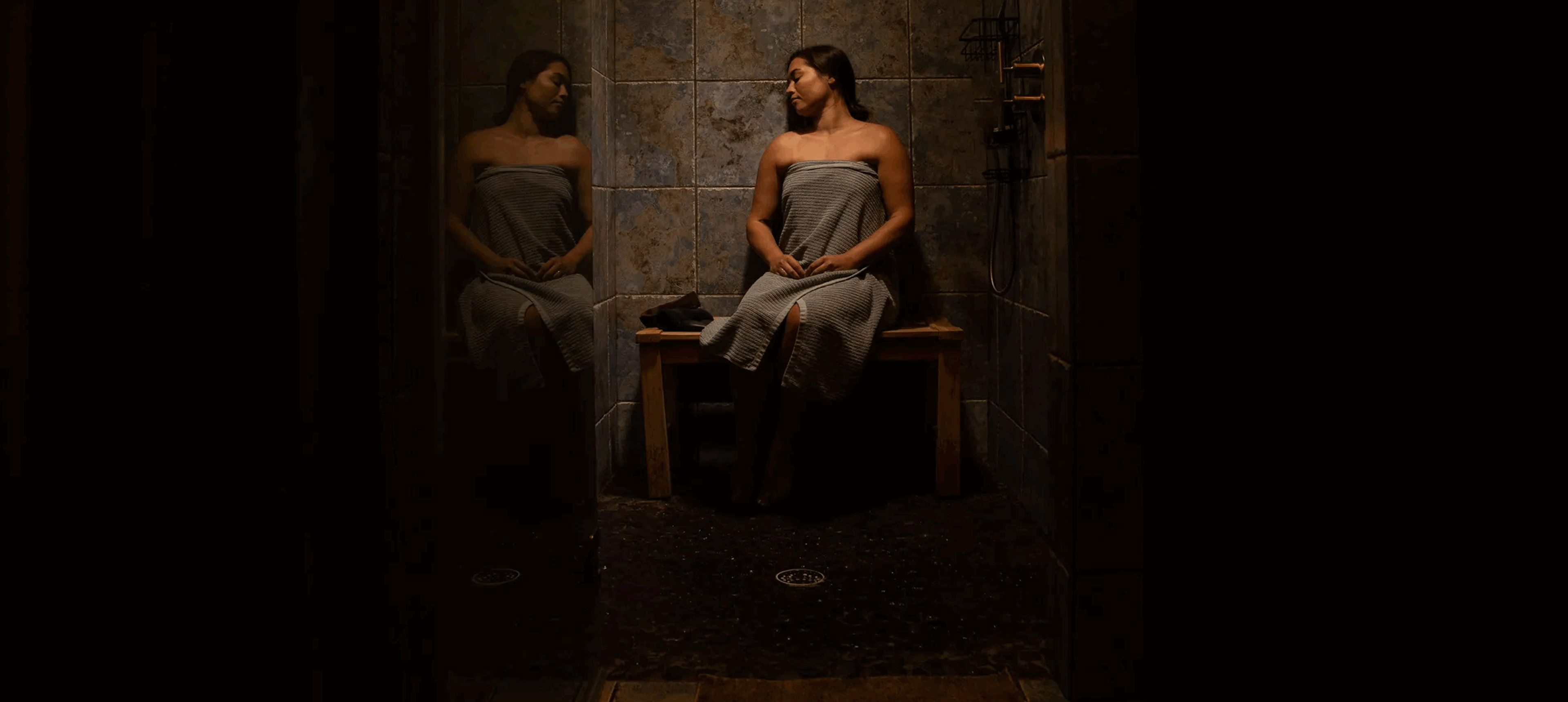 Woman wrapped in towel sitting alone