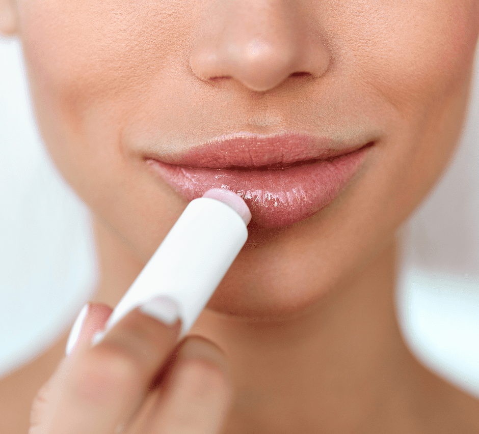 Woman applying lip balm