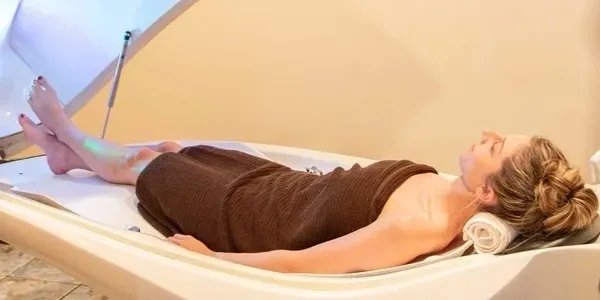 Person lying down in a medical scanner for imaging.